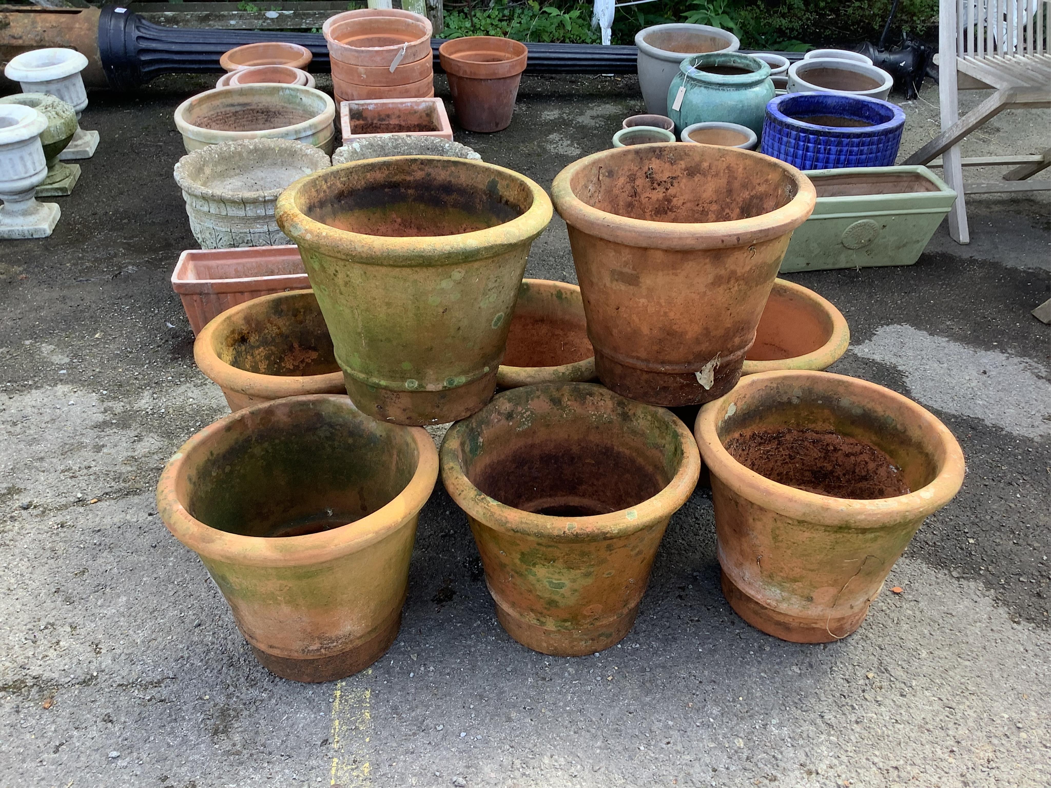 A matching set of eight terracotta garden pots, height 33cm, diameter 38cm. Condition - used and weathered